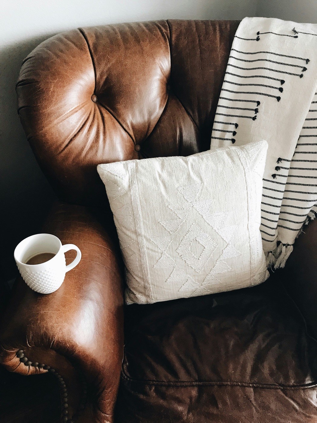 Brown leather tufted armchair, cleaned and conditioned